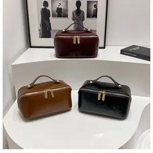 Large capacity PU leather cosmetic bag detail view, showing colors and metal zippers.