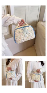 Close-up details of quilted floral cosmetic bag, portable makeup storage pouch with zipper.