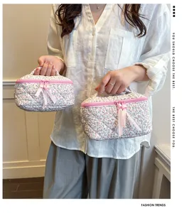Floral quilted cosmetic bag with pink bow, portable travel makeup pouch and toiletry organizer.