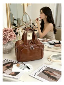 Detail view of the brown leather cosmetic bag, large capacity travel toiletry organizer.