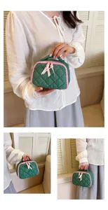 Green quilted cosmetic bag with pink polka dots, cute cotton travel makeup storage pouch.