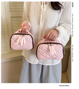 Cute quilted polka dot cosmetic bag with ribbon and handle, soft cotton makeup storage pouch.