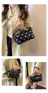 Black and white polka dot cosmetic bag, chic PU leather makeup pouch for daily use.