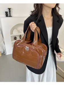 Brown glossy cosmetic storage bag detail, multi-functional travel toiletry bag with zip.