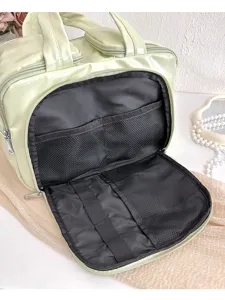 Detail view of the multi-functional large capacity cosmetic bag interior with mesh pockets.