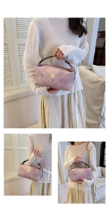 Detail view of vintage pink PU cosmetic bag, portable travel makeup storage pouch.