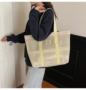 Large beige mesh tote bag detail showcasing durable fabric and comfortable shoulder straps.
