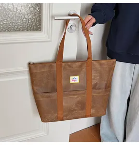 Large brown mesh tote bag scene detail, portable shoulder travel bag with durable straps.
