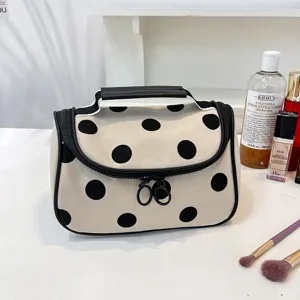 Large capacity polka dot cosmetic bag with handle, portable canvas makeup storage pouch for travel.