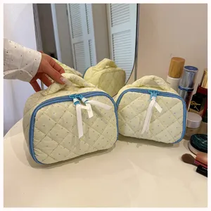 Quilted polka dot cosmetic bag cute cotton makeup pouch with bow zipper for travel daily use.
