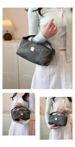 Vintage washed denim cosmetic bag with metal logo, large capacity portable makeup pouch for women.