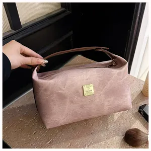 Vintage PU cosmetic bag with large capacity, portable handle and smooth zipper closure.