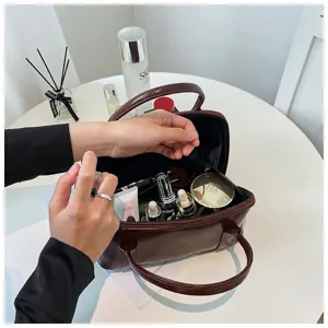 Portable brown leather cosmetic bag with large capacity and multi-compartment daily storage.