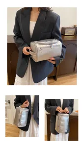 Detailed view of large capacity silver PU leather cosmetic bag with handy zipper and handle.