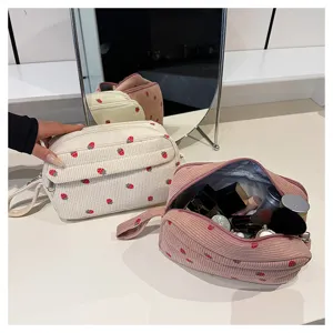Corduroy strawberry cosmetic bag with large capacity, portable handle, and cute travel makeup pouch.