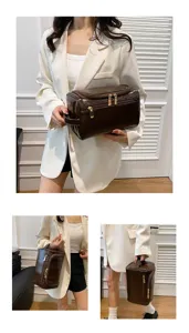 Detail view of brown PU leather cosmetic bag, showing large capacity and sturdy handle.