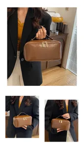 Brown PU leather cosmetic bag with dual zippers and top handle for travel and daily storage.
