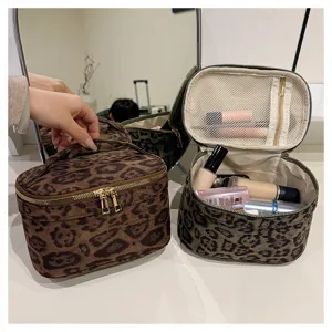 Detail view of the leopard print cosmetic bag, featuring spacious interior, mesh pockets and dual zippers.