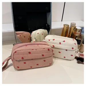 Corduroy strawberry cosmetic bag detail view, large capacity portable storage pouch for travel.