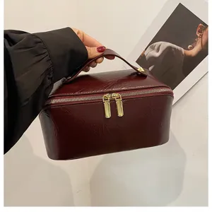 Solid color PU leather cosmetic bag, large capacity makeup storage bag for travel toiletry use.