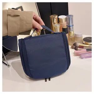Detail view of large capacity navy blue hanging toiletry bag cosmetic organizer pouch.