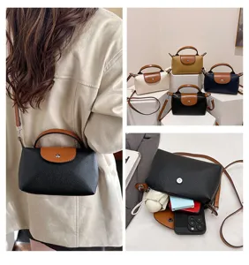 Women's leather dumpling crossbody handbag, fashionable color-block shoulder bag for daily use.