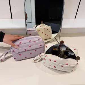 Corduroy cosmetic bag with cute strawberry pattern, large capacity portable makeup organizer.