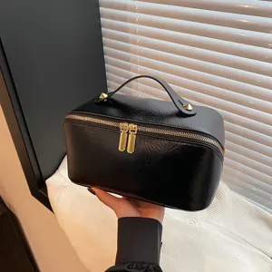 Solid color PU leather cosmetic bag large capacity travel toiletry bag with zipper.