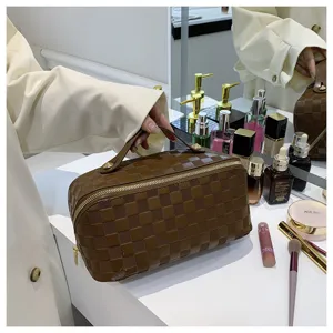 Brown checkerboard cosmetic bag large capacity makeup organizer with sturdy handle.