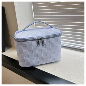 Large capacity checkered cosmetic bag with handle and zipper for travel daily use.