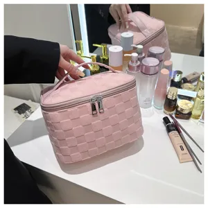 Pink woven cosmetic bag with large capacity, stylish portable makeup organizer for travel and daily use.