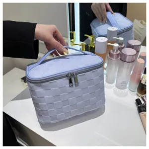 Large capacity woven cosmetic bag with handle, stylish blue makeup organizer for travel.
