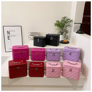 Portable quilted cosmetic storage train case with sturdy top handle and smooth double zippers.