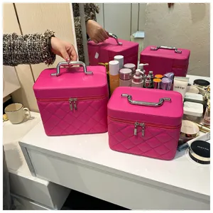 Detailed view of pink quilted cosmetic case, portable makeup train box with silver handle.