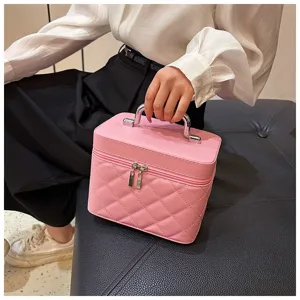 Stylish pink quilted cosmetic bag with metal handle, portable makeup storage case for travel.