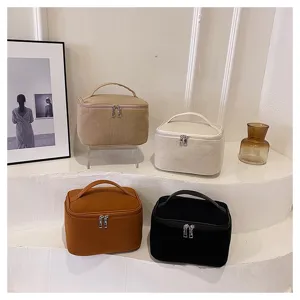 Minimalist corduroy cosmetic bag detail, solid color portable storage pouch for daily travel.