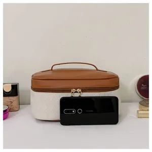 Detailed view of the stylish two-tone quilted PU cosmetic bag featuring a sturdy handle and zipper.
