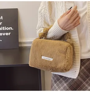 Detailed closeup of a fluffy brown cosmetic handbag with plush handle and cute label accent.