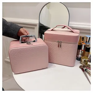 Pink PU leather cosmetic storage bag with quilted design and sturdy handle for travel use.