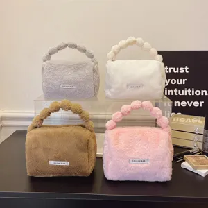 Fluffy plush cosmetic bag with unique bubble handle, soft autumn winter handbag for women.