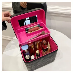 Detail view of the black PU leather makeup train case with pink interior and mirror.