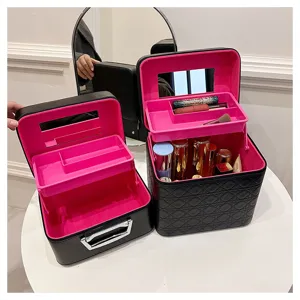 Black PU leather makeup train case with pink interior, multi-tier tray and built-in mirror.