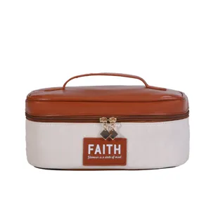 Stylish color-block quilted PU cosmetic bag with portable handle and large storage capacity.