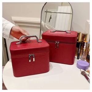 Estuche de maquillaje de cuero PU rojo organizador de cosmeticos con asa de metal y patron acolchado.