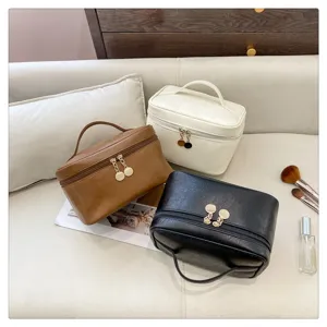 Detailed view of solid color PU leather cosmetic organizer bag with large storage capacity.