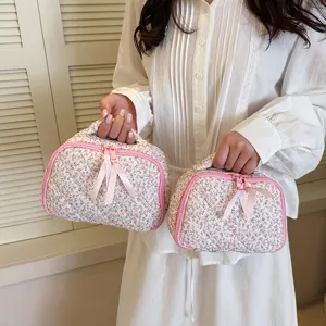 Portable quilted floral cosmetic bag with diamond lattice design, perfect for daily makeup storage.