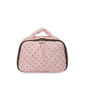 Cute pink polka dot quilted cosmetic bag with top handle and bow zip, ideal for daily makeup storage.