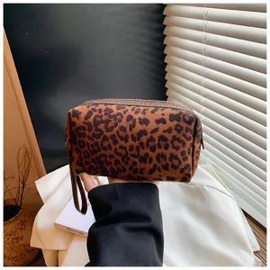 Detail view of a vintage leopard print cosmetic bag, portable travel makeup storage pouch.