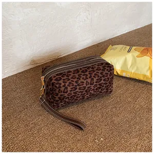 Leopard print cosmetic bag for women, portable travel makeup pouch with wrist strap detail.