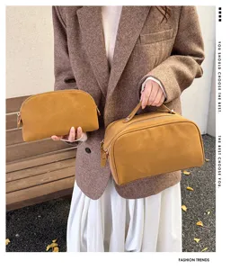 Detail shot of brown PU leather cosmetic pouch and matching vanity bag, elegant design.